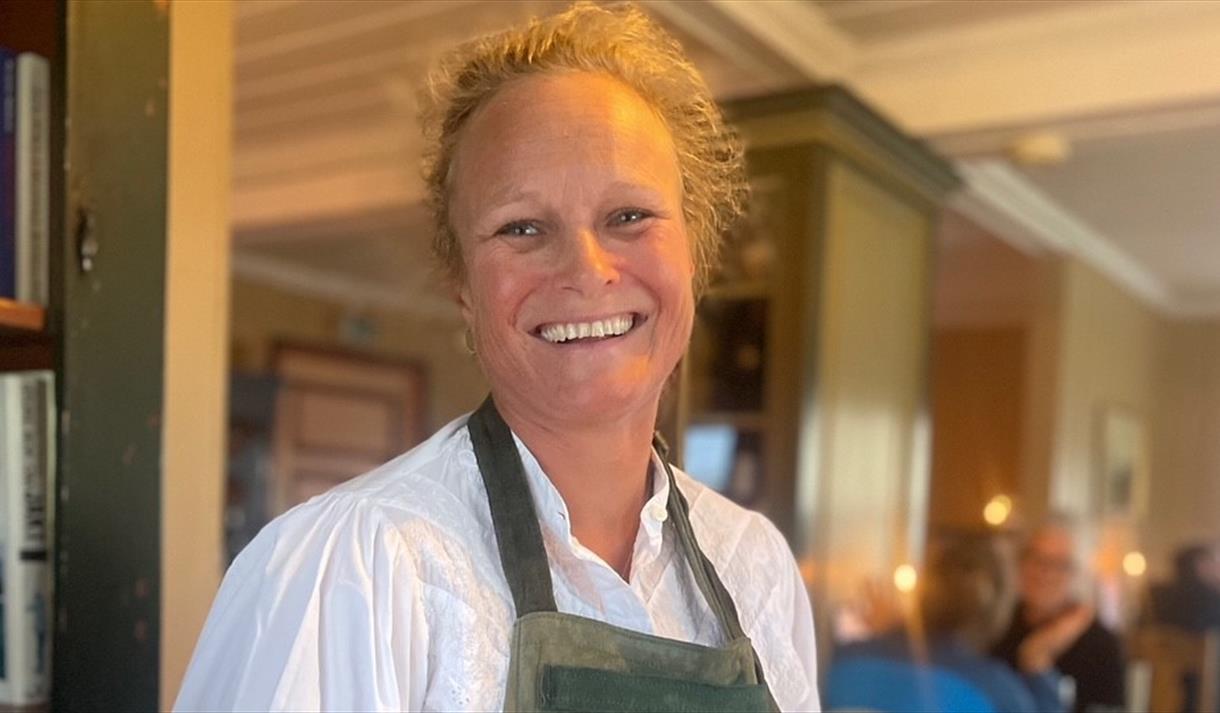 Kristin Gluck-Teigland med gamalost. Foredrag på Vest-Telemark musuem.