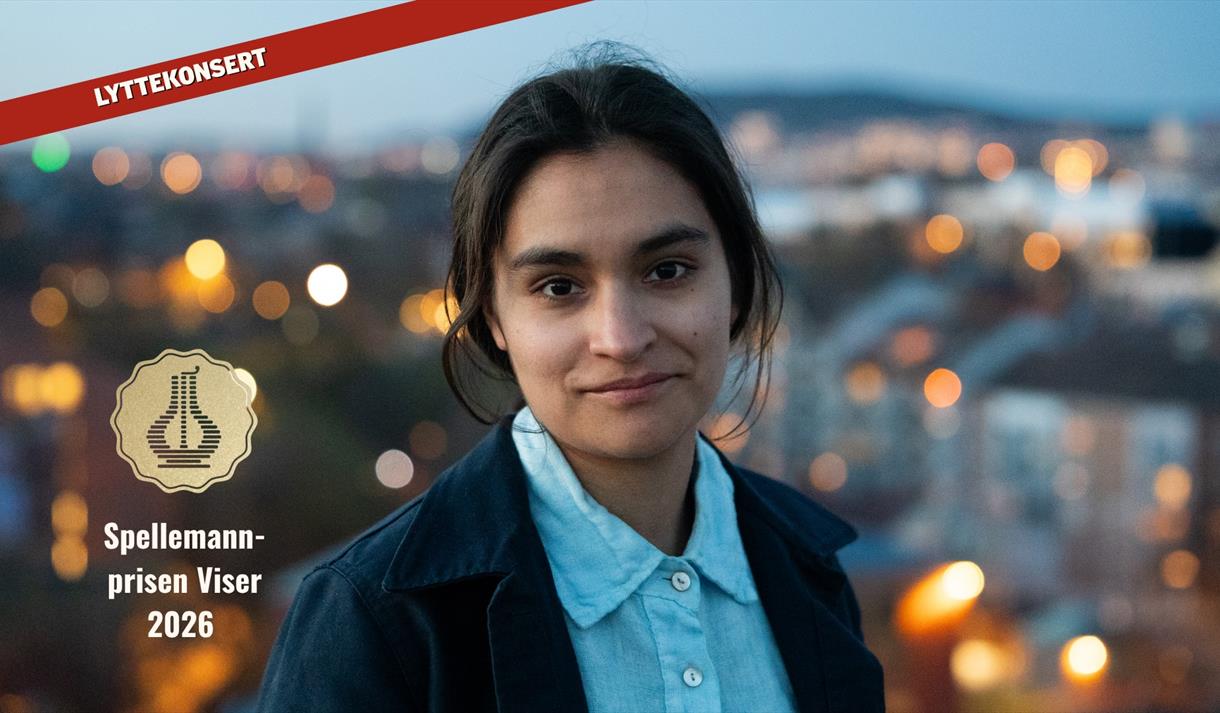 mørk dame med blå skjorte med lys i bakgrunn