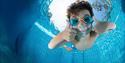 gutt som dykker i basseng på Skien fritidspark